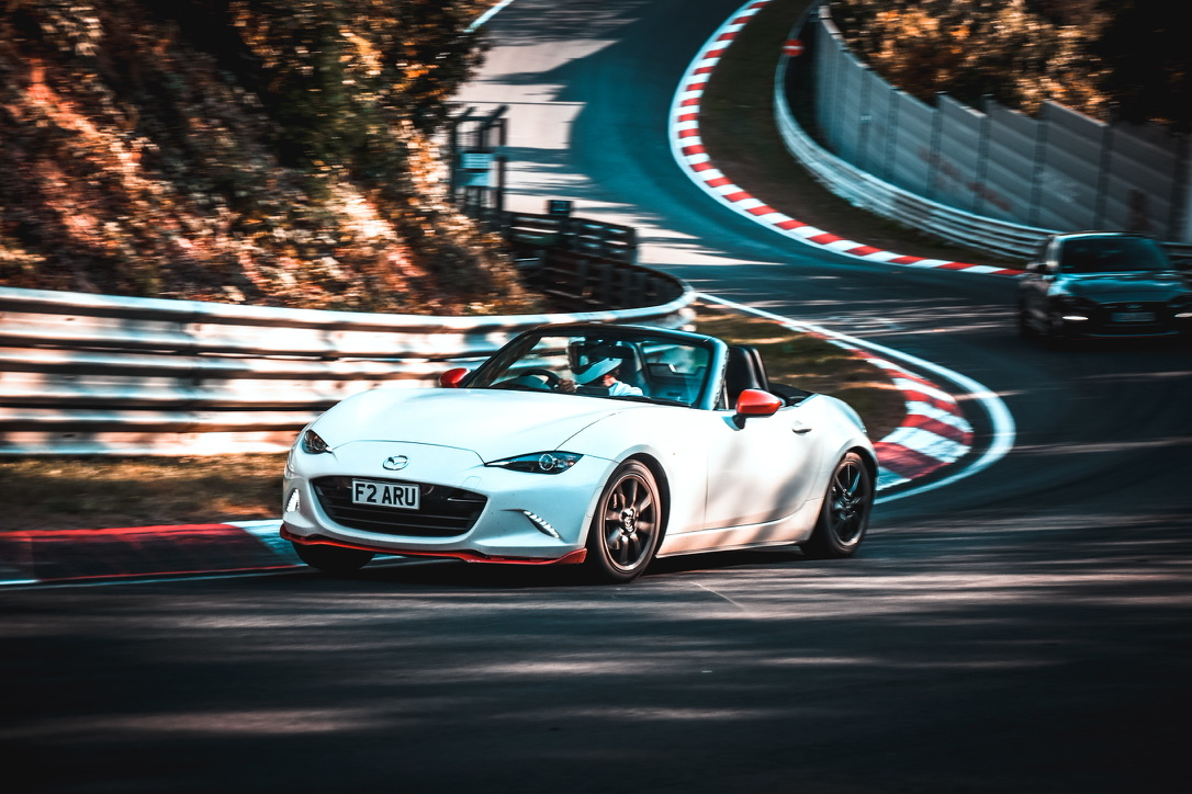 Mazda MX-5 trailing another car through a Nürburgring bend